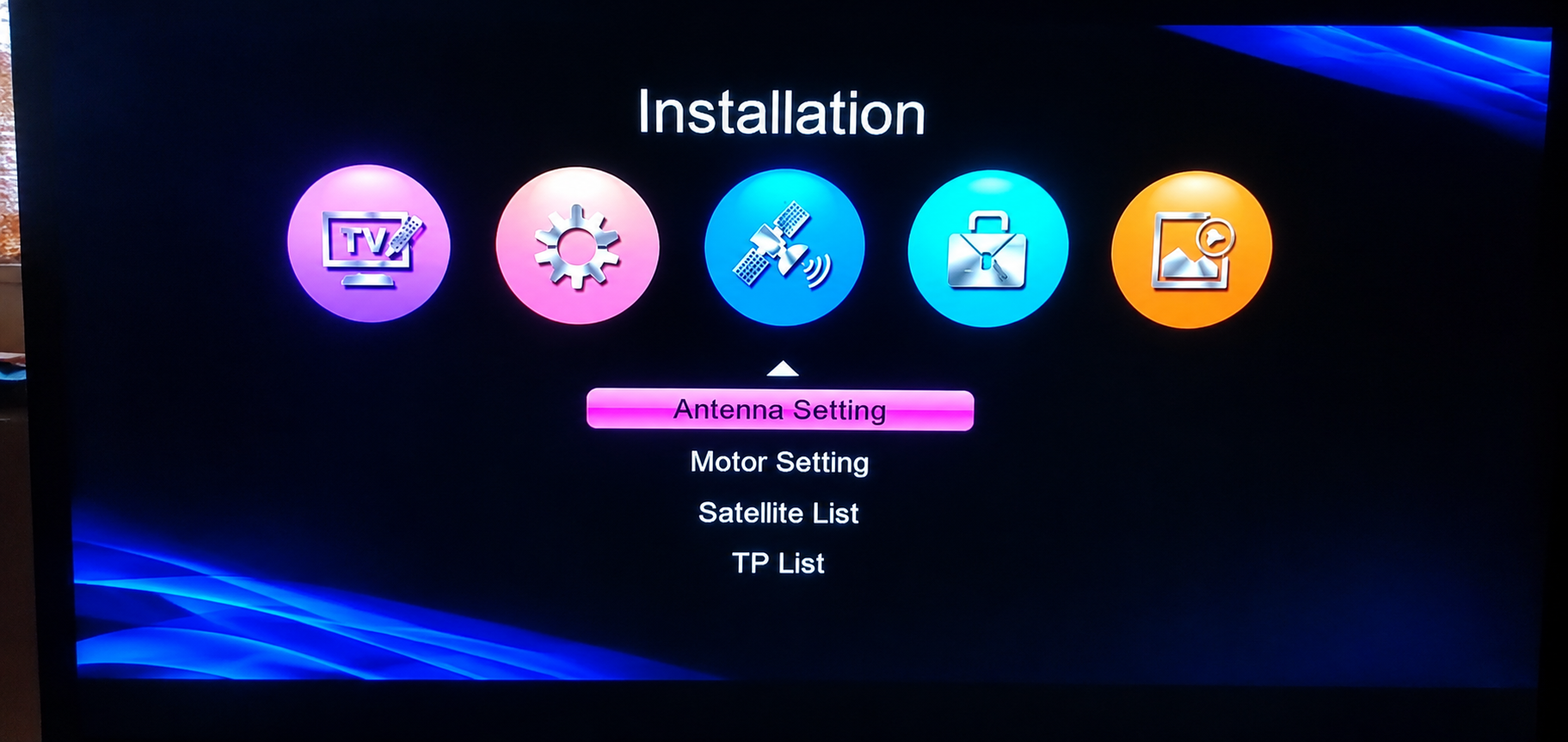 Installation menu on the receiver screen with Antenna Setting, Motor Setting, Satellite List and TP List